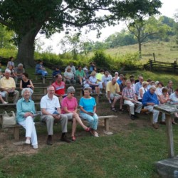 The congregation enjoys the good weather before service starts.